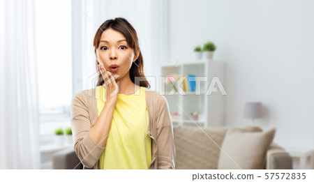 surprised asian woman at home 57572835