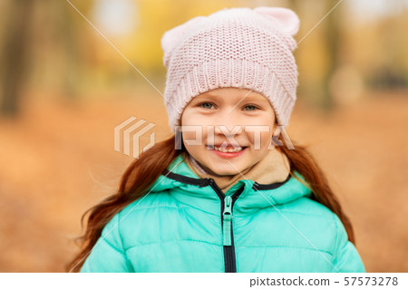 portrait of happy little girl at autumn park 57573278