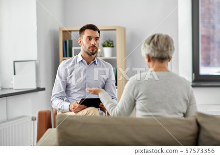 psychologist listening to senior woman patient psychologist listening to senior woman patient 57573356