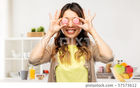 happy asian woman with eyes of macarons happy asian woman with eyes of macarons 57573612