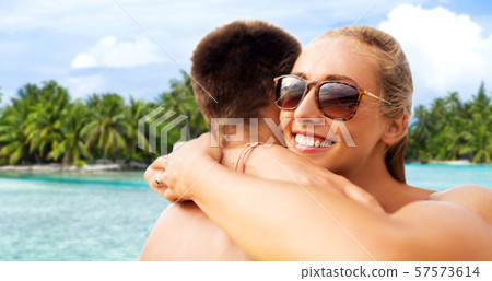 happy couple hugging on summer beach 57573614