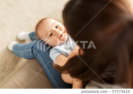 young mother with little asian baby son at home young mother with little asian baby son at home 57573616