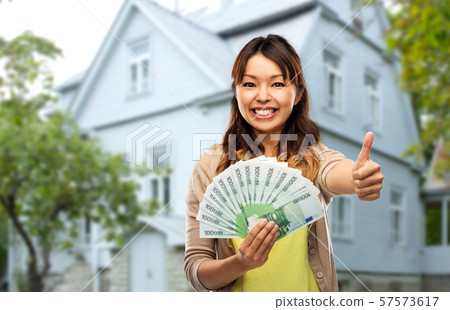 asian woman with euro money showing thumbs up asian woman with euro money showing thumbs up 57573617