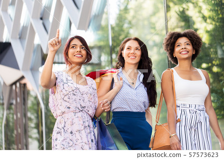happy women with shopping bags in city happy women with shopping bags in city 57573623