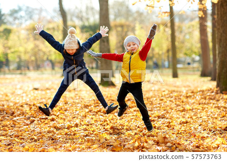 happy children running at autumn park happy children running at autumn park 57573763