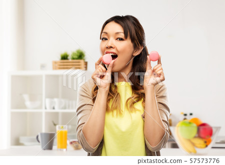happy asian woman with macarons happy asian woman with macarons 57573776