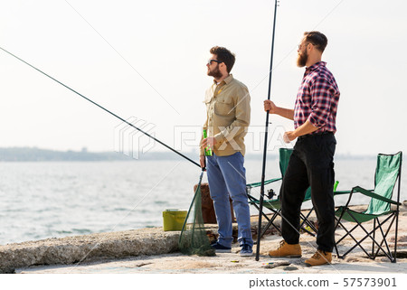 male friends with fishing rods and beer on pier male friends with fishing rods and beer on pier 57573901
