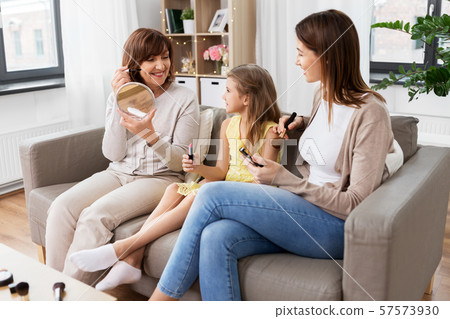 mother, daughter and grandmother doing make up mother, daughter and grandmother doing make up 57573930