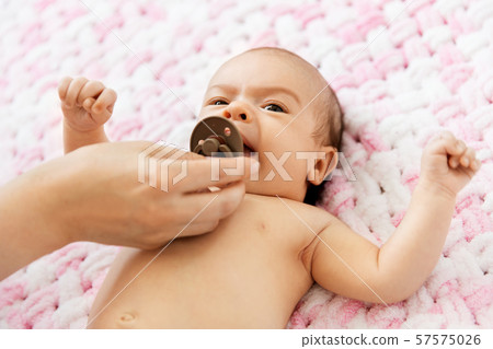 giving pacifier to baby