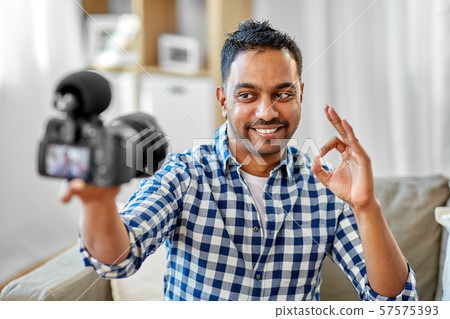 male video blogger with camera blogging at home 57575393