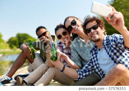 friends with drinks taking selfie by smartphone friends with drinks taking selfie by smartphone 57576351