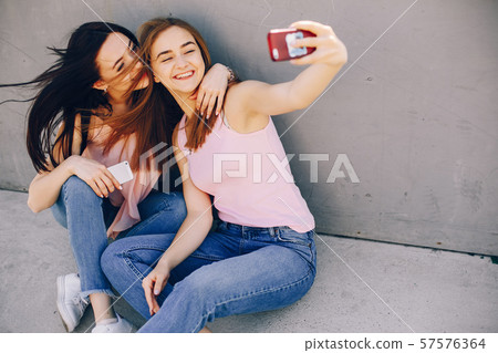 two beautiful girls in a park two beautiful girls in a park 57576364