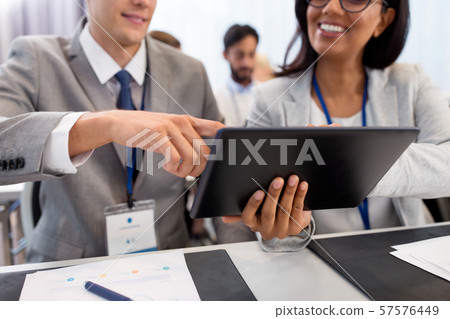 people with tablet computer at business conference 57576449