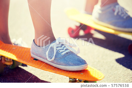 close up of feet riding skateboards on city street close up of feet riding skateboards on city street 57576538