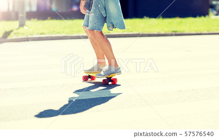 teenage boy on skateboard crossing city crosswalk 57576540