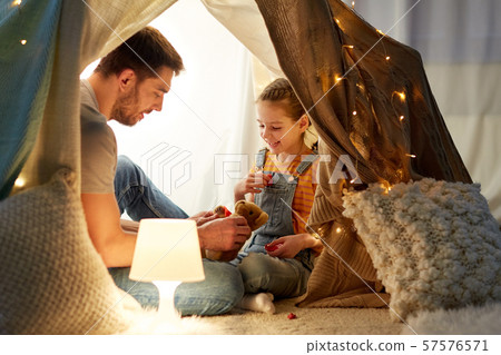 happy family playing with toy in kids tent at home happy family playing with toy in kids tent at home 57576571