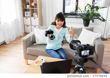 asian female blogger with camera recording video 57576642