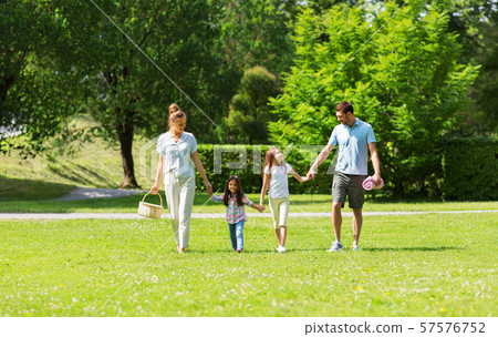 family with picnic basket walking in summer park 57576752