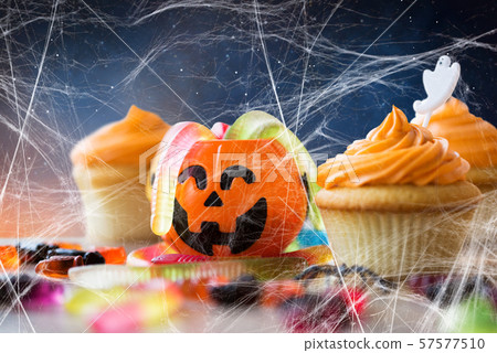 halloween party cupcakes and candies on table 57577510
