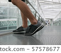 Male feet wearing sneakers 57578677