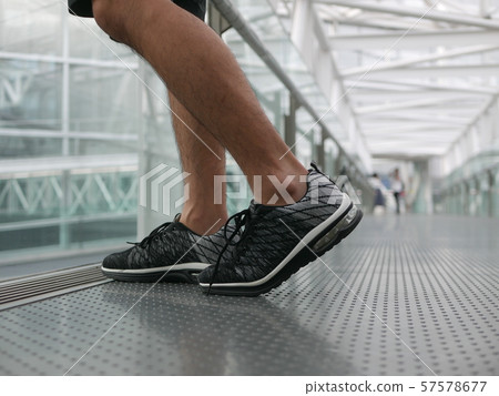 Male feet wearing sneakers 57578677