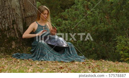 Playing The Instrument Hung. Woman Hands Playing The Hang outdoors. 57578887