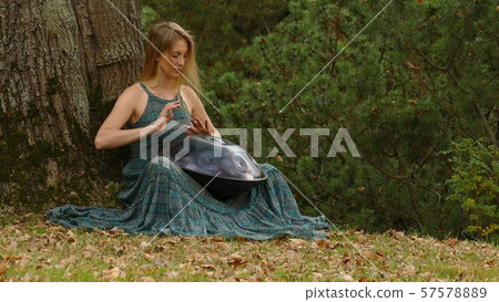 Playing The Instrument Hung. Woman Hands Playing The Hang outdoors. 57578889