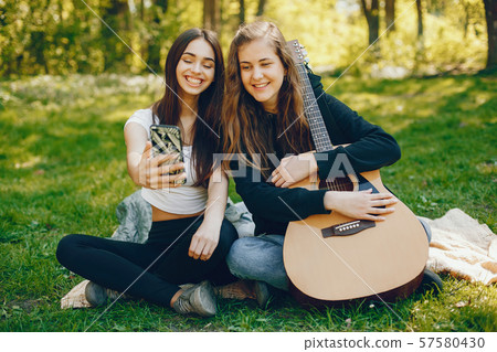 Two girls with a guitar 57580430