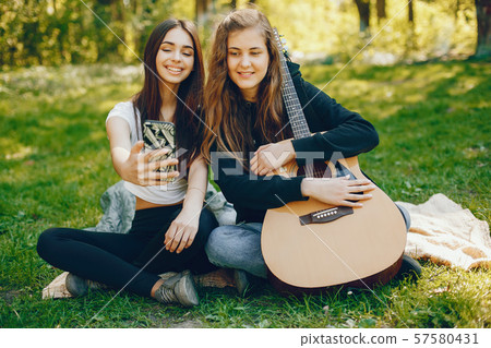 Two girls with a guitar 57580431