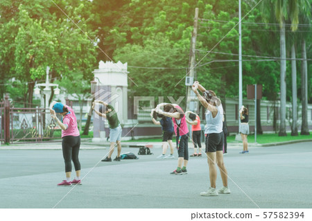 Group of elderly friend doing aerobic dance after work together at Lumpini Park in Bangkok, Thailand. Group of elderly friend doing aerobic dance after work together at Lumpini Park in Bangkok, Thailand. 57582394