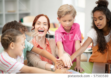 Children and teacher enjoying their friendly team Children and teacher enjoying their friendly team 57583580