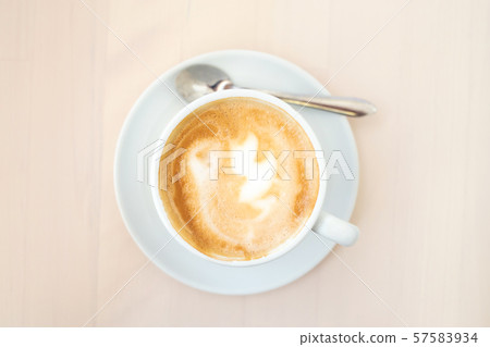 A cup of cappuccino on the table. A cup of cappuccino on the table. 57583934