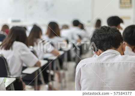 Blur school background university students writing answer doing exam in classroom Blur school background university students writing answer doing exam in classroom 57584377