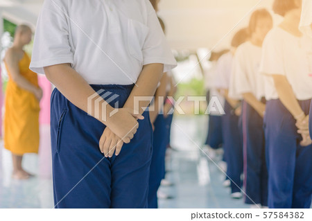 Group of students try to meditate for the peace of mind by walk with Buddhist monk in school. Group of students try to meditate for the peace of mind by walk with Buddhist monk in school. 57584382
