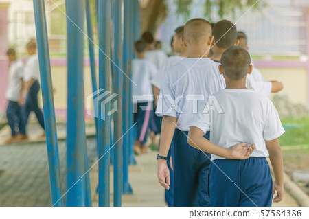 Group of students try to meditate for the peace of mind by walk with Buddhist monk in school. Group of students try to meditate for the peace of mind by walk with Buddhist monk in school. 57584386