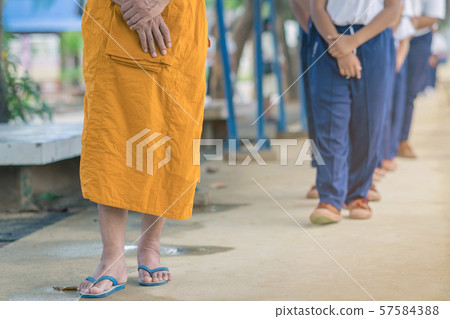 Group of students try to meditate for the peace of mind by walk with Buddhist monk in school. Group of students try to meditate for the peace of mind by walk with Buddhist monk in school. 57584388