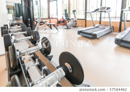 Blur gym background fitness center or health club with blurry sports exercise equipment for aerobic workout and bodybuilding 57584462