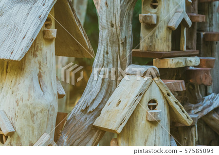 Hand made wooden bird house nest in public Park , hand wood shelter for birds Hand made wooden bird house nest in public Park , hand wood shelter for birds 57585093