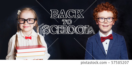 Cute smart kids boy and girl on blackboard Cute smart kids boy and girl on blackboard 57585207