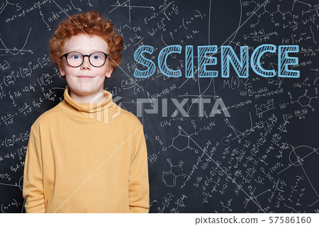 Smart little boy with red ginger hair on science 57586160