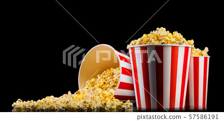 Set of paper striped buckets with popcorn isolated on black background Set of paper striped buckets with popcorn isolated on black background 57586191