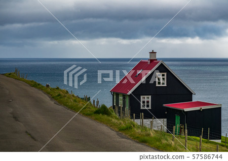 House near ocean and road in Faroe Islands House near ocean and road in Faroe Islands 57586744