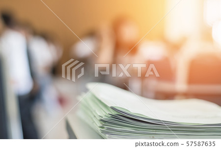 Exam answer sheet or application paper blurry view on table in examination room with blur education background of school university students taking exam test writing answer in seat row with stress Exam answer sheet or application paper blurry view on table in examination room with blur education background of school university students taking exam test writing answer in seat row with stress 57587635