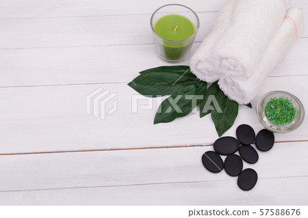 Spa still life with aromatic candles, orchid flower and stones Spa still life with aromatic candles, orchid flower and stones 57588676