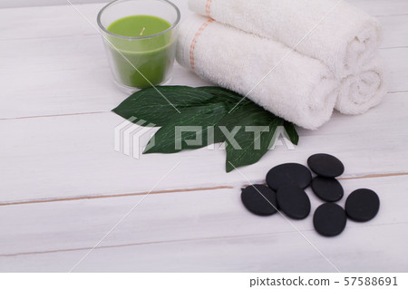 Spa still life with aromatic candles, orchid flower and stones Spa still life with aromatic candles, orchid flower and stones 57588691