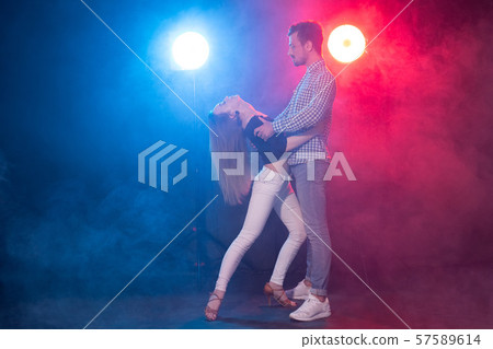 Social dance, kizomba, salsa and semba concept - young beautiful couple dancing bachata or salsa in 57589614