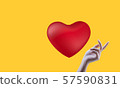 Red heart, yellow background and beautiful woman's hand 57590831