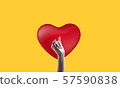 Red heart, yellow background and beautiful woman's hand 57590838