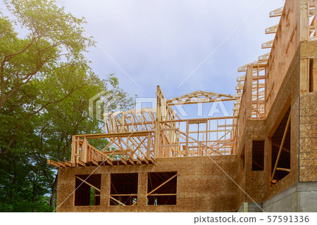 Looking up new construction beams under a clear Looking up new construction beams under a clear 57591336