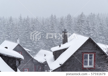 Snow covered roof of a wood house Snow covered roof of a wood house 57591679